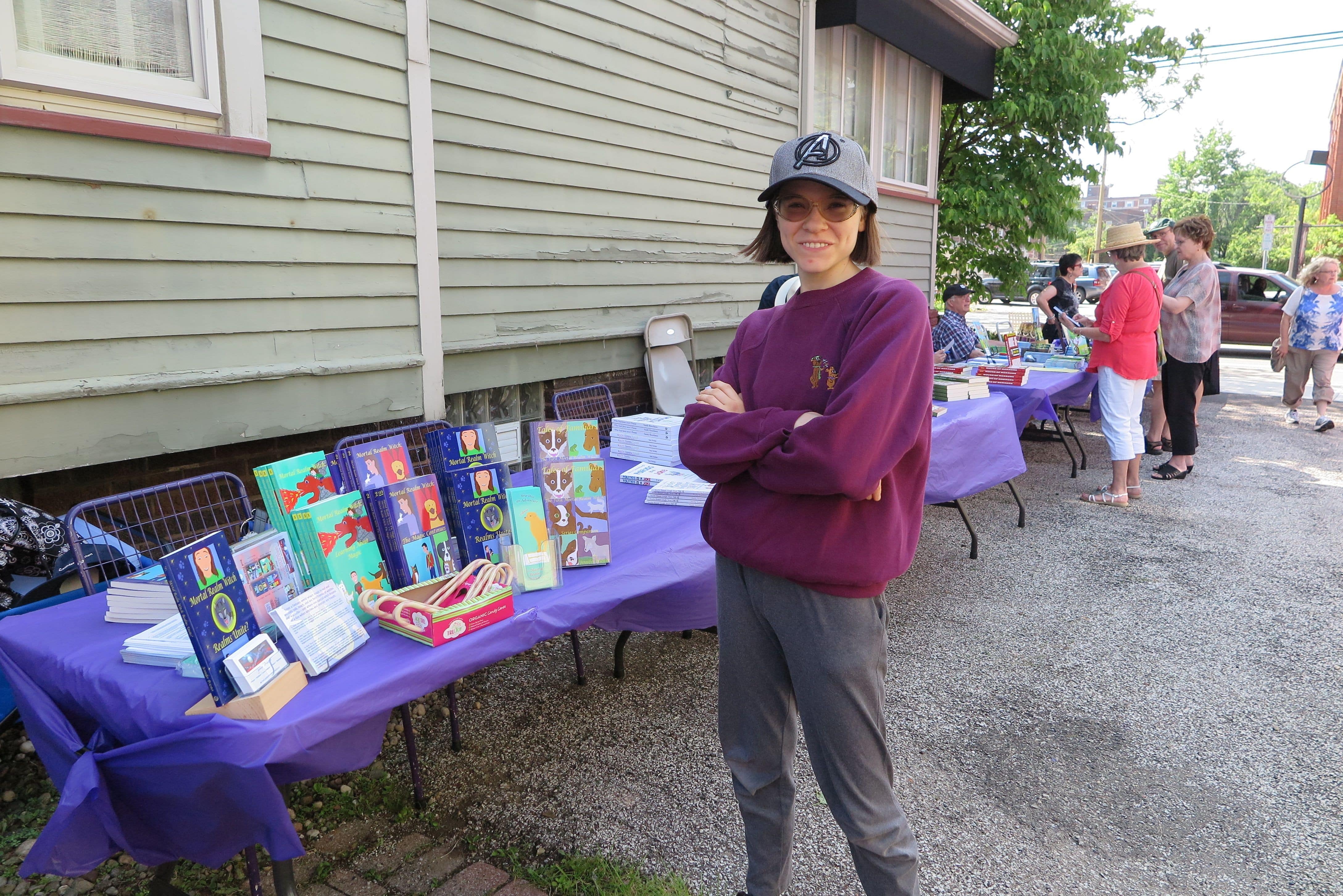 Jennifer Priester with her books at an outdoor vendor event.