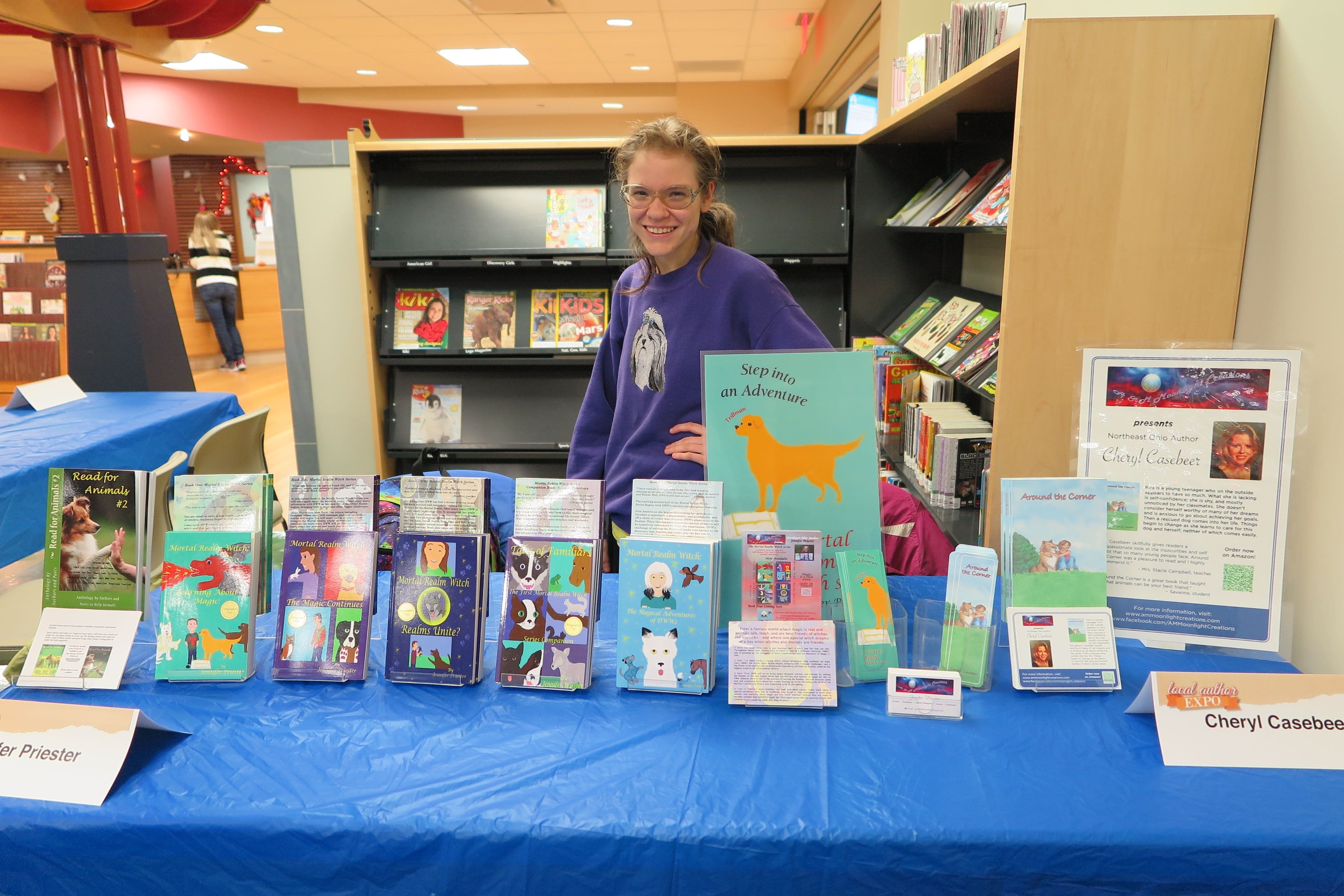 Jennifer Priester with her books at a library author event.